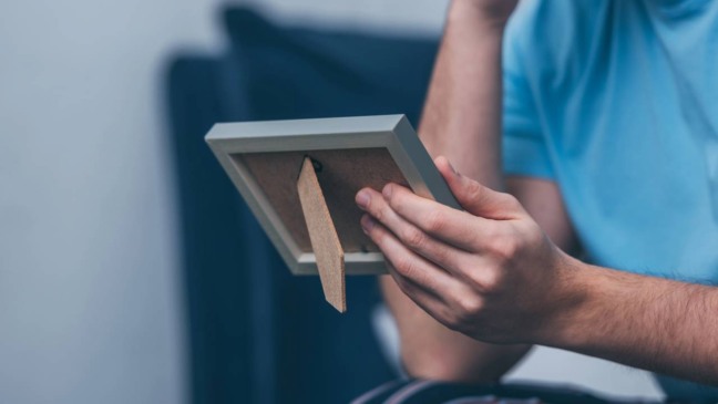 Expressão de melancolia ao lembrar do passado, ilustrando o impacto emocional da nostalgia frequente