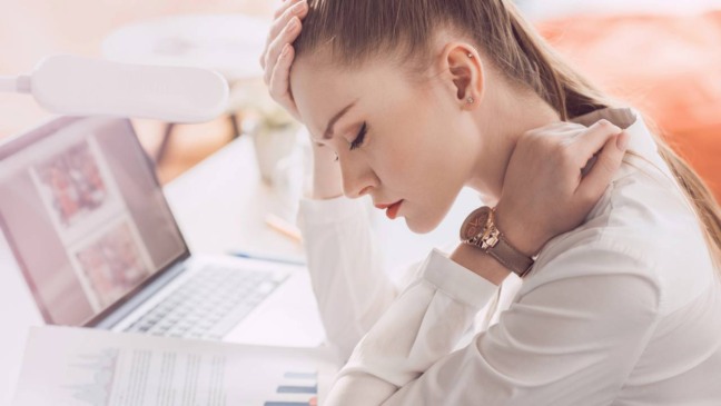 Pessoa sentada demonstrando cansaço e fraqueza, associados à falta de vitamina B12