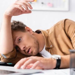 Indiv&iacute;duo sentado com postura abatida indicando esgotamento mental