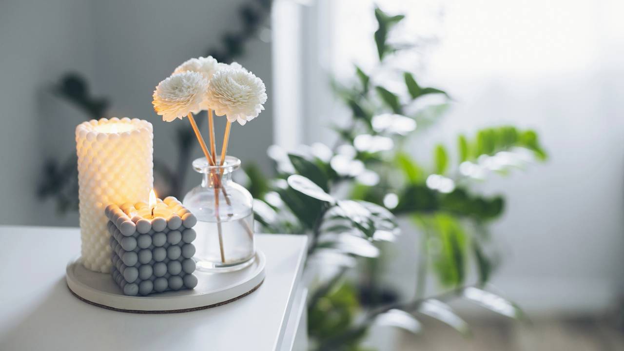 Vela arom&aacute;tica acesa em ambiente dom&eacute;stico contribuindo para sensa&ccedil;&atilde;o de aconchego.